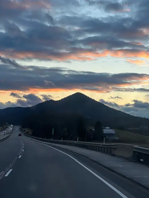 Sky on fire, mountains dark, the journey unfolds.